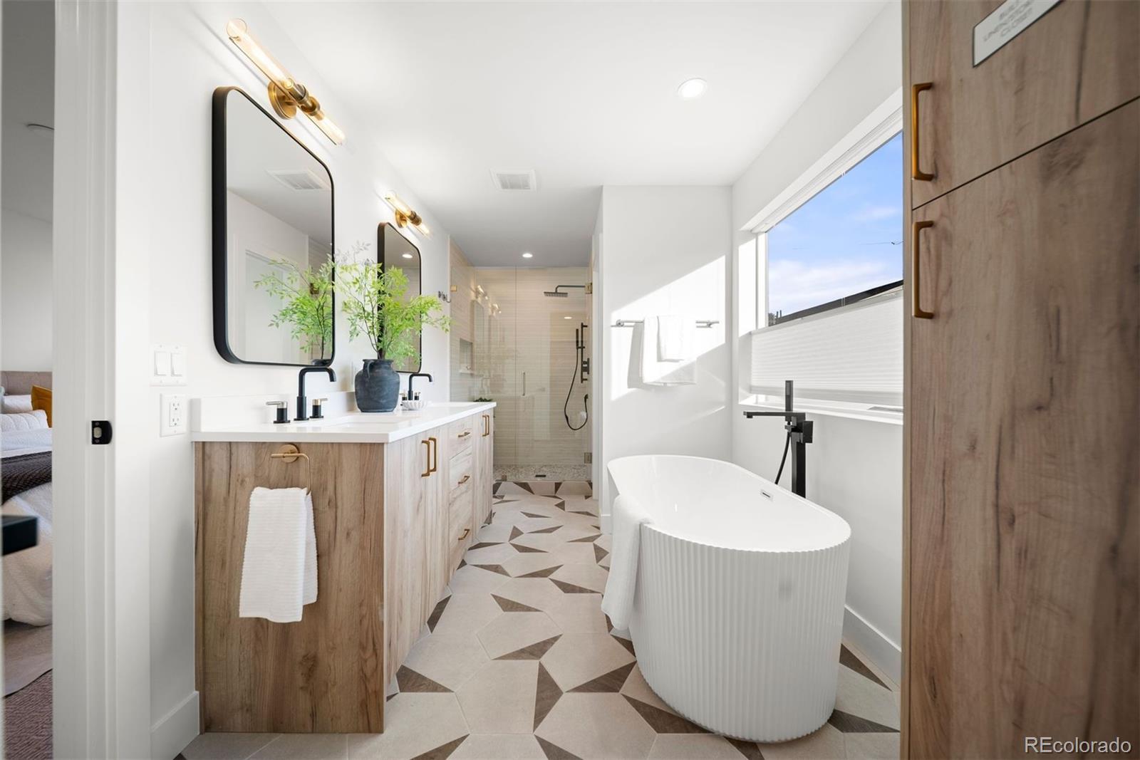 2452 South Cherokee Street Denver, CO 80223 - Photo 19 of 34 a bathroom with a sink mirror and toilet
