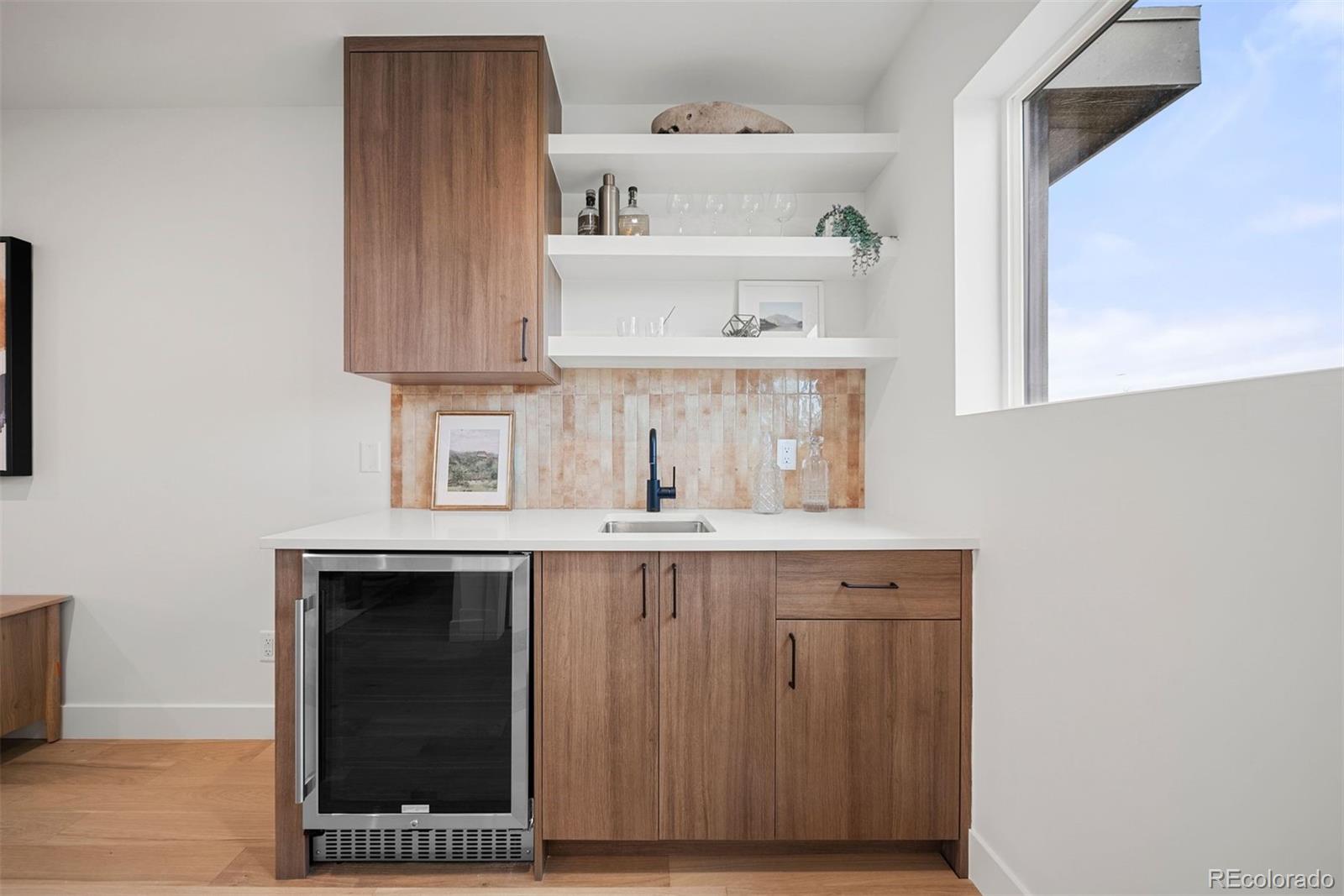 2452 South Cherokee Street Denver, CO 80223 - Photo 22 of 34 a kitchen with a sink and cabinets
