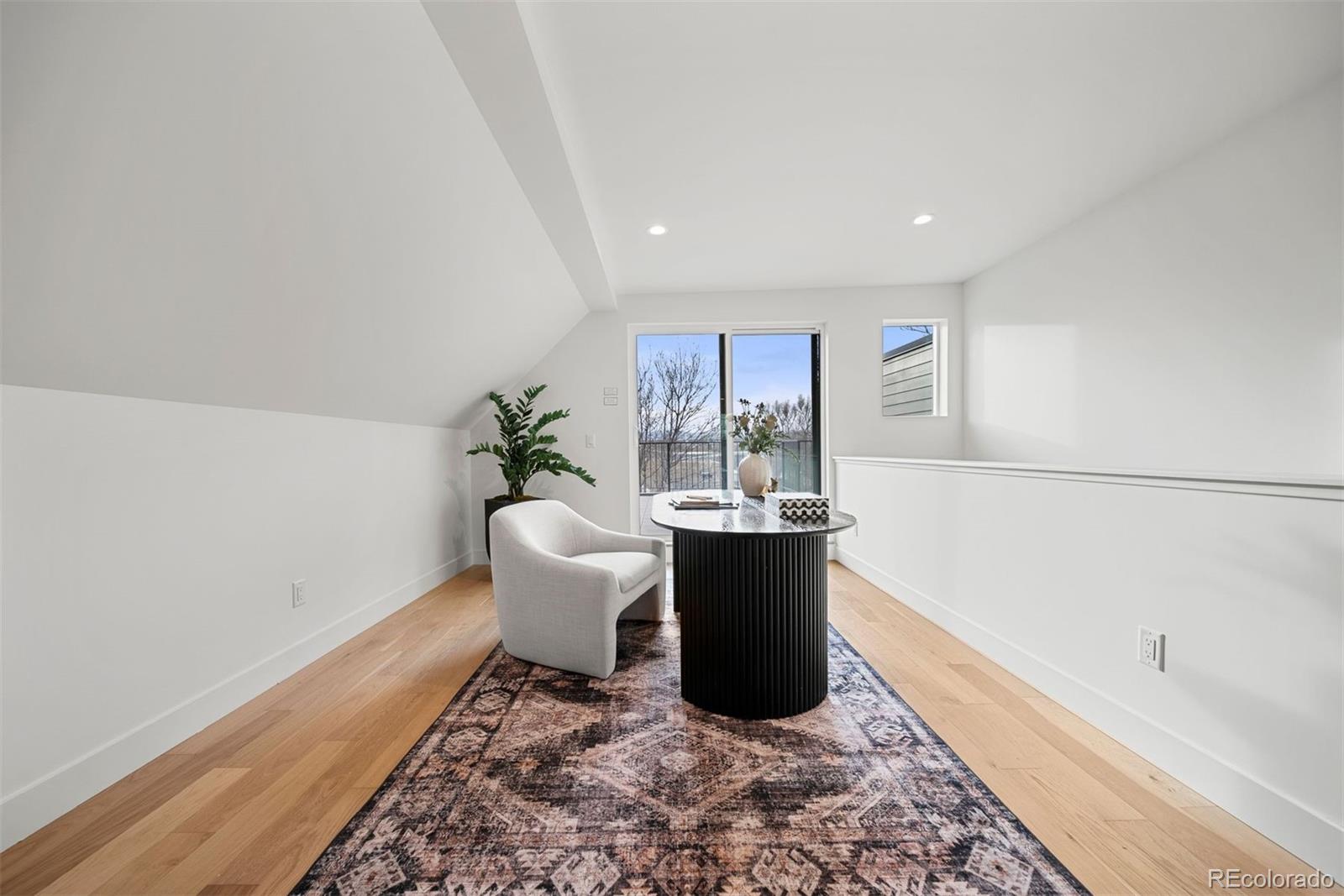2452 South Cherokee Street Denver, CO 80223 - Photo 25 of 34 a living room with a couch and a potted plant