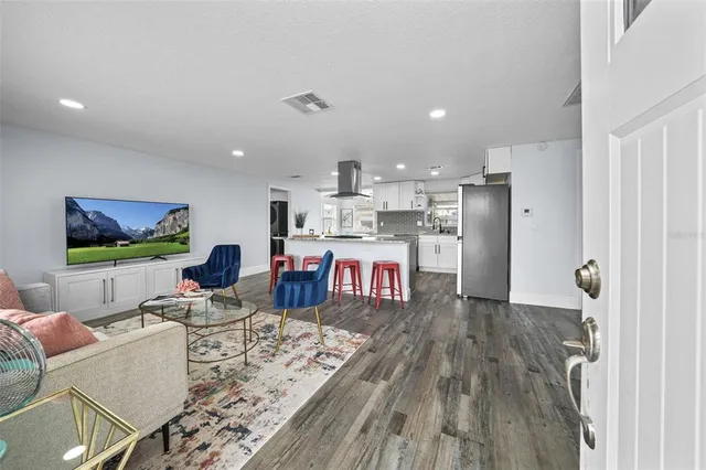 a living room with furniture and wooden floor