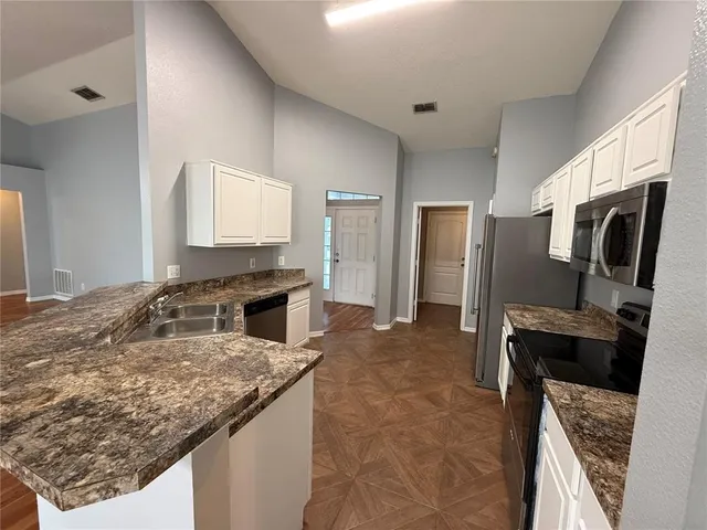 a kitchen with a refrigerator sink and stove