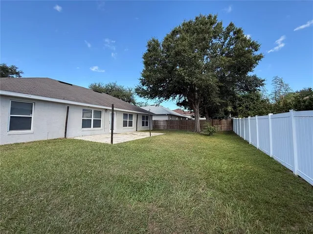 a view of a house with a yard and a garden