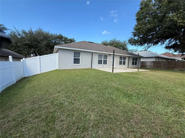 a bathroom with a granite countertop toilet a sink and shower