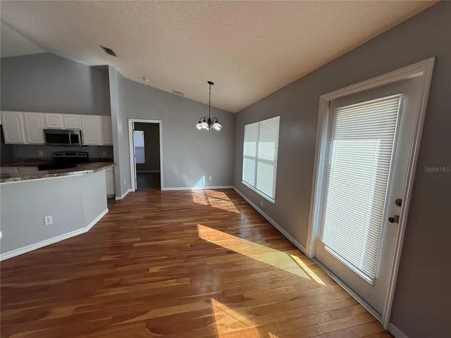 a view of a kitchen from the hallway