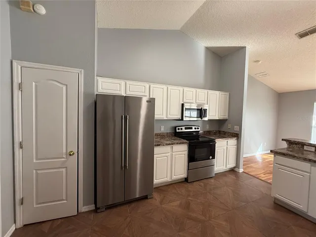 a kitchen with a refrigerator stove and sink
