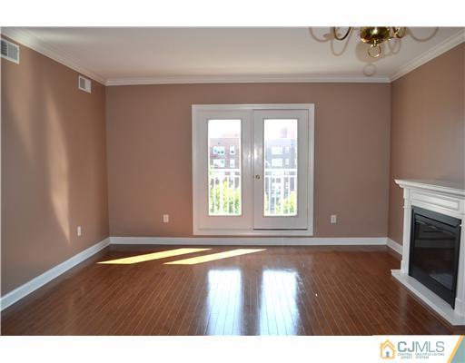 358 Rector Street, Unit 608 Perth Amboy, NJ 08861 - Photo 3 of 24 a view of empty room with wooden floor and fan