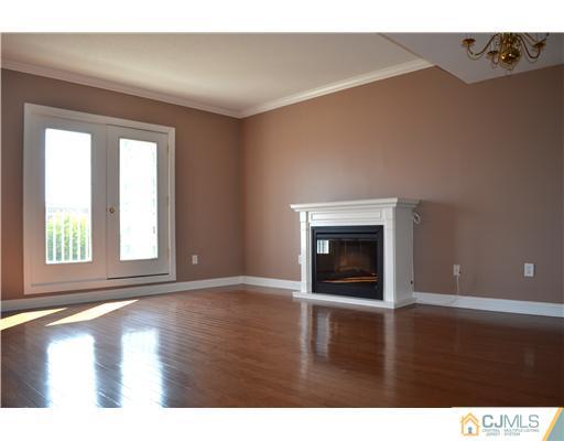 358 Rector Street, Unit 608 Perth Amboy, NJ 08861 - Photo 4 of 24 a view of an empty room with wooden floor and a window
