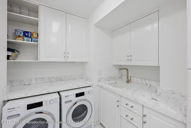 a utility room with sink dryer and washer