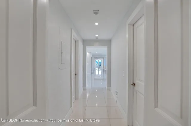 a view of a hallway with wooden shelves
