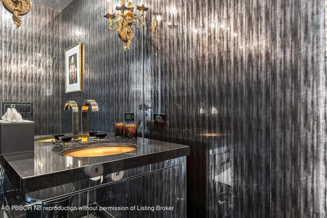 a bathroom with a sink vanity and mirror