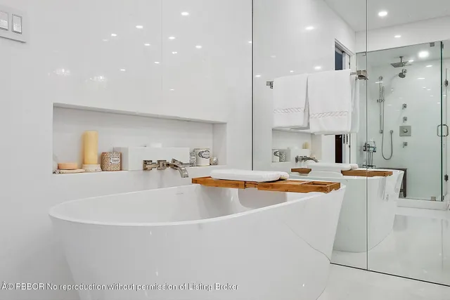 a large white kitchen with a large window