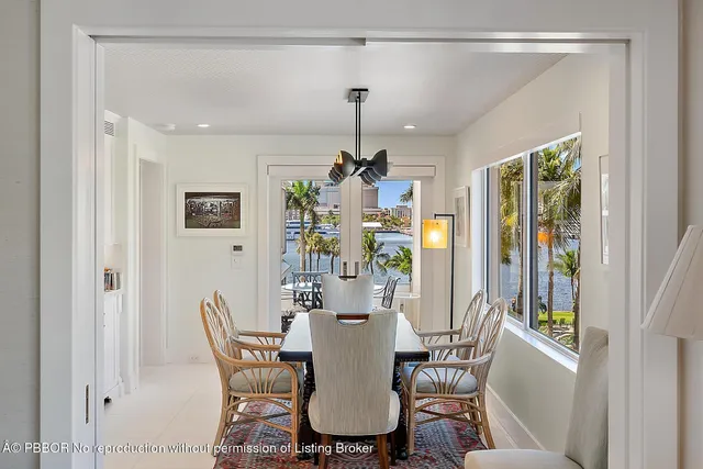 a dining room with furniture a chandelier and window