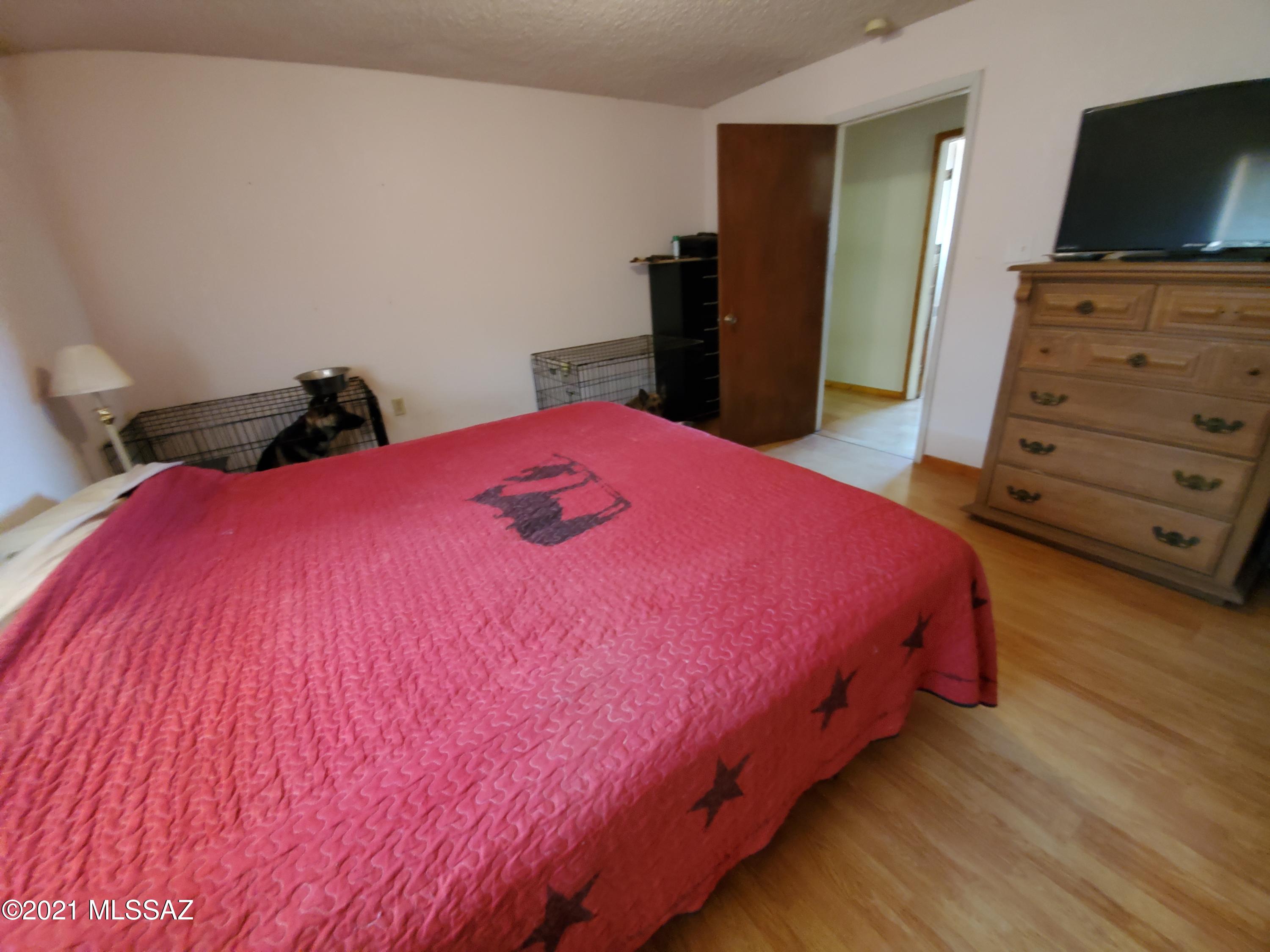 3440 East Howling Wolf Road Willcox, AZ 85643 - Photo 16 of 45 a bed room with a bed and a television