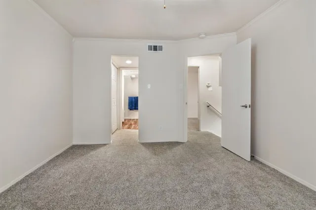 an empty room with closet and a bathroom