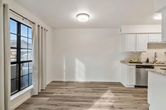 a view of kitchen with sink and cabinets