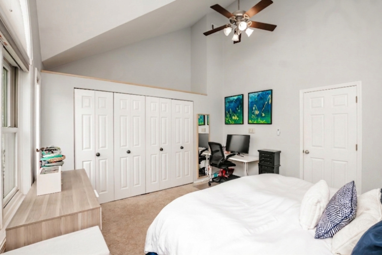 1139 West Roscoe Street Chicago, IL 60657 - Photo 11 of 28 a bedroom with a bed and wooden floor
