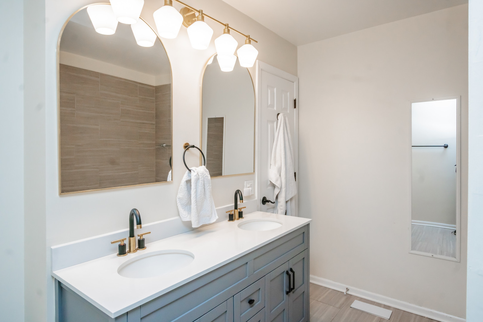 1139 West Roscoe Street Chicago, IL 60657 - Photo 17 of 28 a bathroom with a sink vanity and a mirror