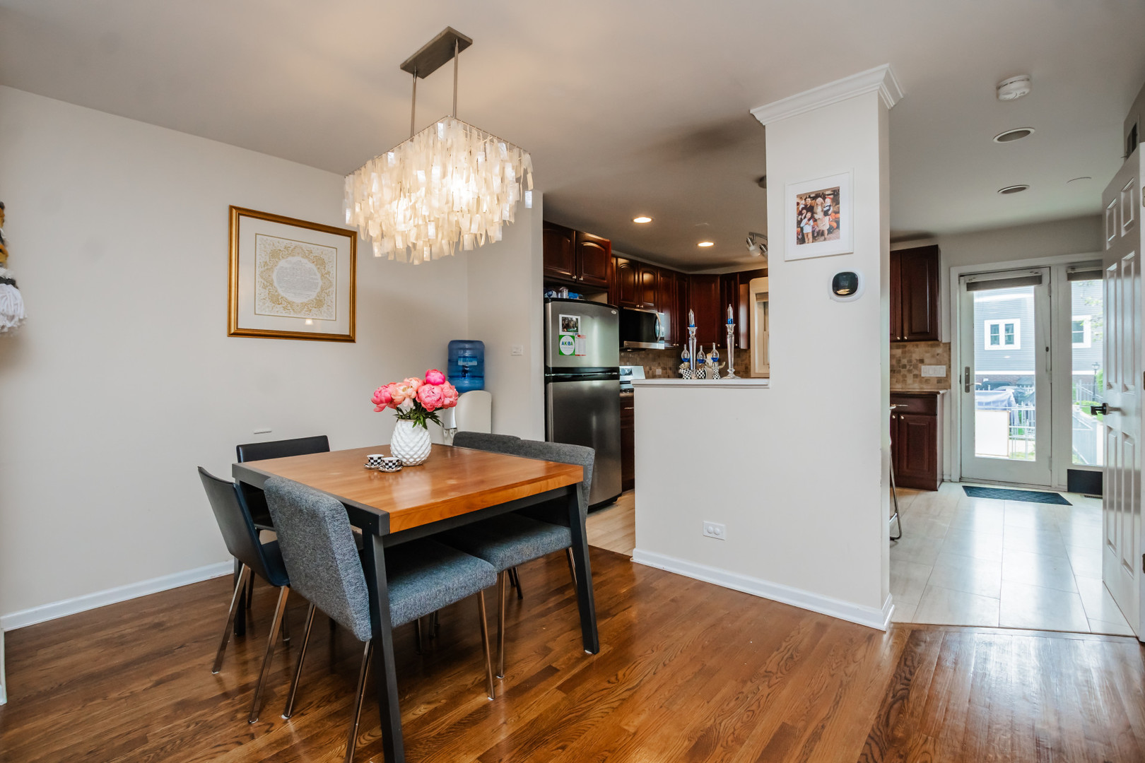 1139 West Roscoe Street Chicago, IL 60657 - Photo 5 of 28 a view of a dining room with furniture wooden floor and chandelier