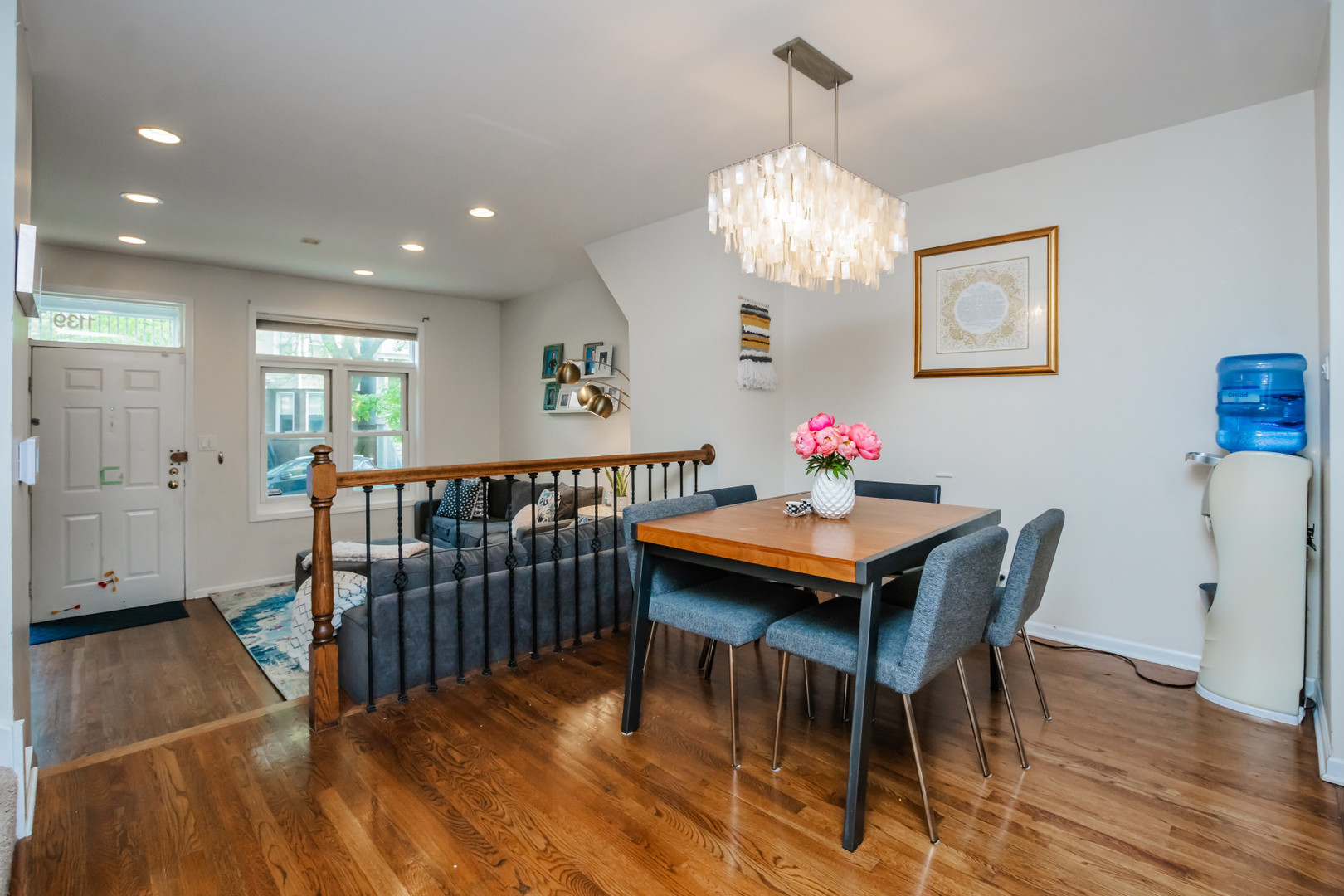 1139 West Roscoe Street Chicago, IL 60657 - Photo 6 of 28 a dining room with furniture a chandelier and wooden floor