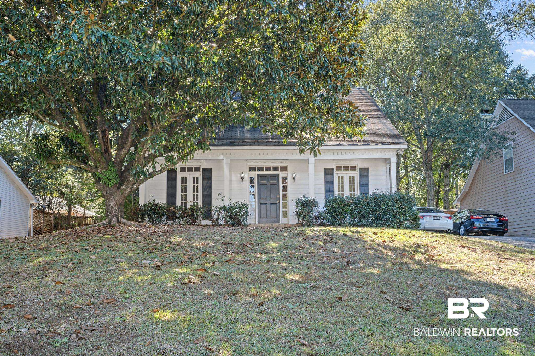6705 Autumn Ridge Drive Mobile, AL 36695 - Photo 2 of 24 View of property hidden behind natural elements featuring a porch and a front yard