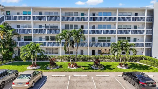 a view of a garden with a chair and tables in the patio