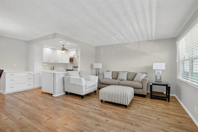 a view of tennis court with lots of trees in the background