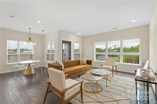 a living room with furniture and large windows