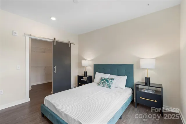 a bedroom with a bed and a refrigerator