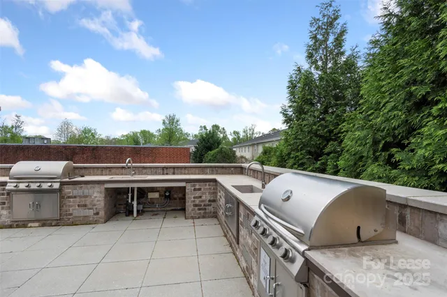 a view of roof deck with furniture