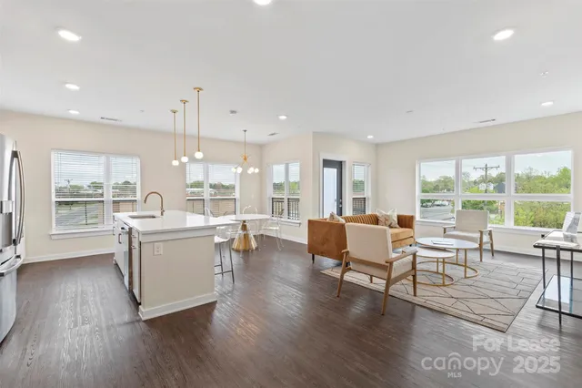 a living room with furniture and large windows
