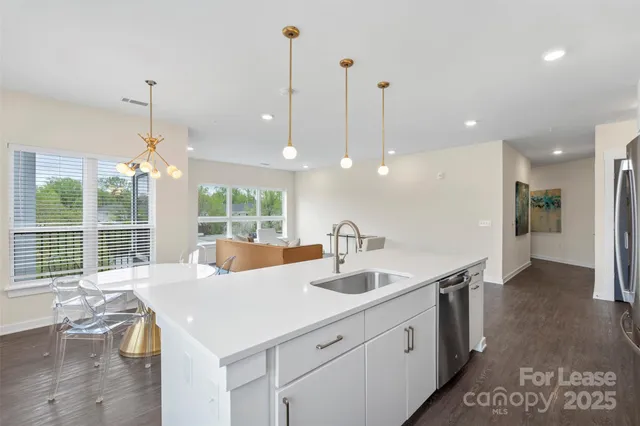a kitchen with center island and stainless steel appliances