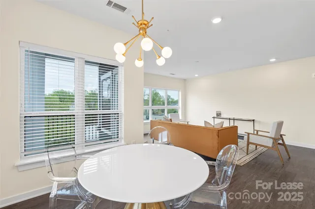 a view of a dining room with furniture wooden floor and chandelier
