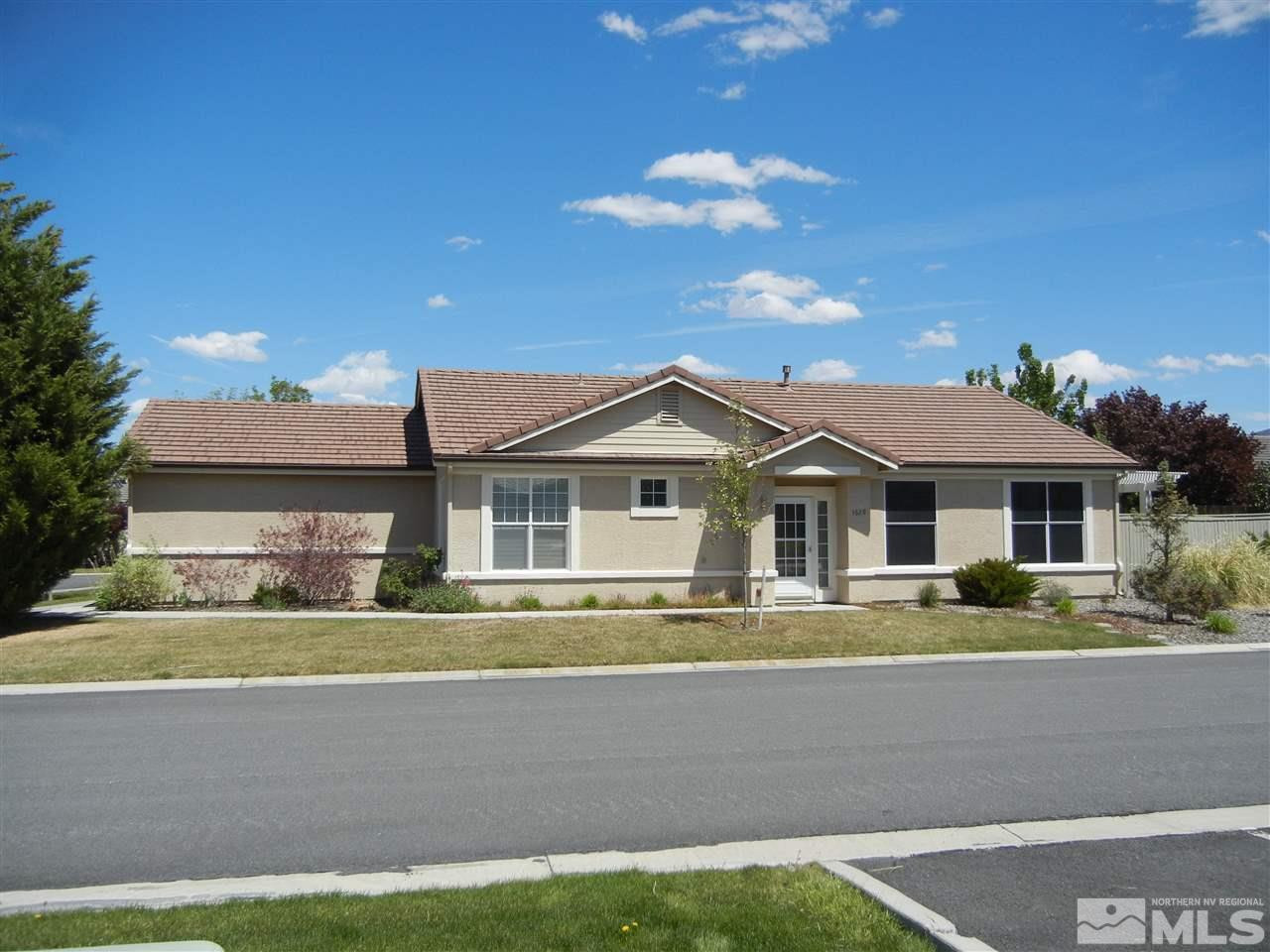 1629 Mountain Lane Reno, NV 89521 - Photo 1 of 1 a front view of a house with a garden and yard