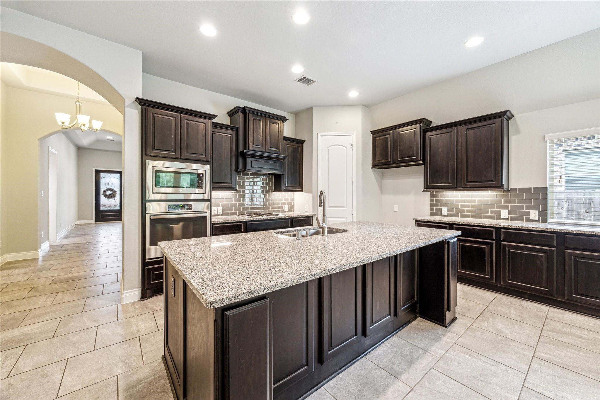 253 Trillium Park Loop Conroe, TX 77304 - Photo 11 of 37 a kitchen with stainless steel appliances granite countertop a sink counter space cabinets and a counter top space