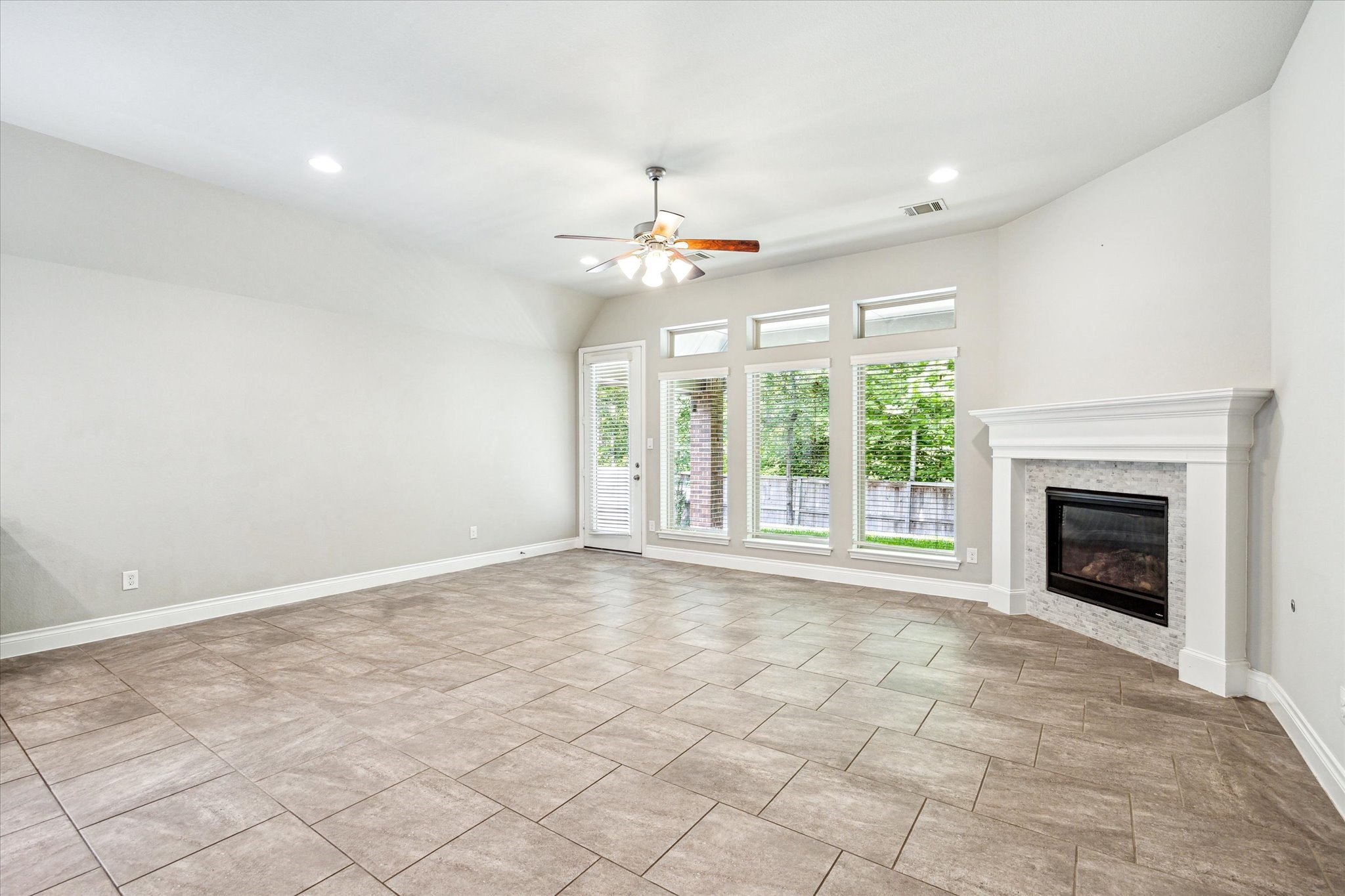 253 Trillium Park Loop Conroe, TX 77304 - Photo 13 of 37 a view of an empty room with a fireplace and a window