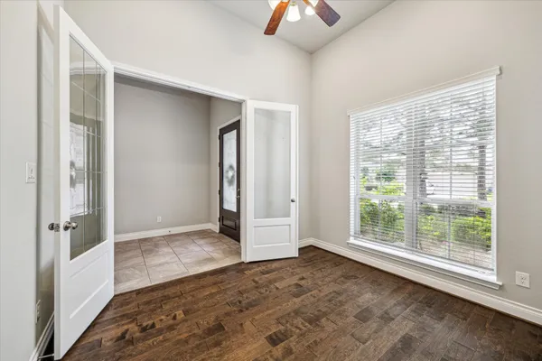 wooden floor in an empty room with a window