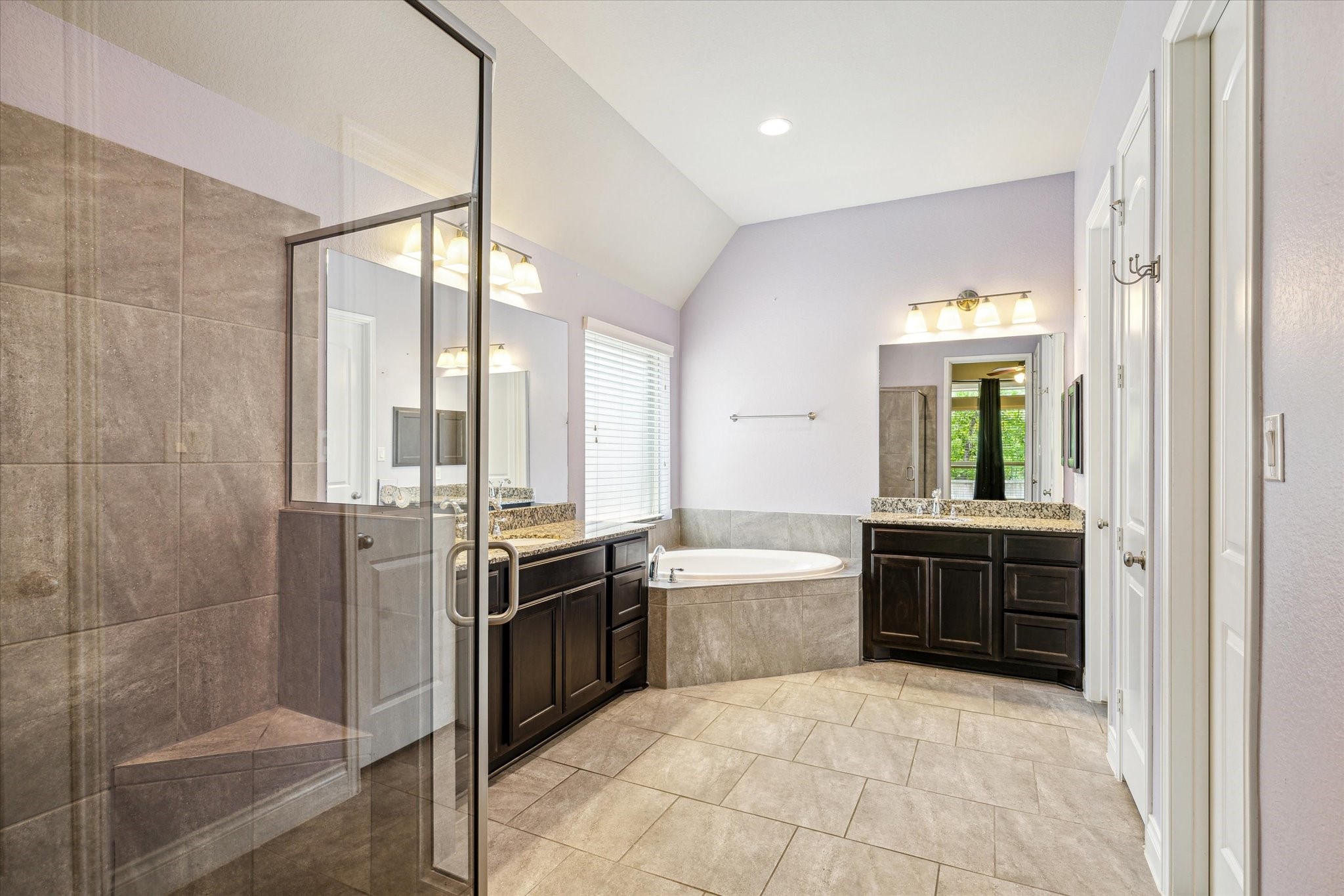 253 Trillium Park Loop Conroe, TX 77304 - Photo 21 of 37 a large kitchen with kitchen island granite countertop a sink and stainless steel appliances