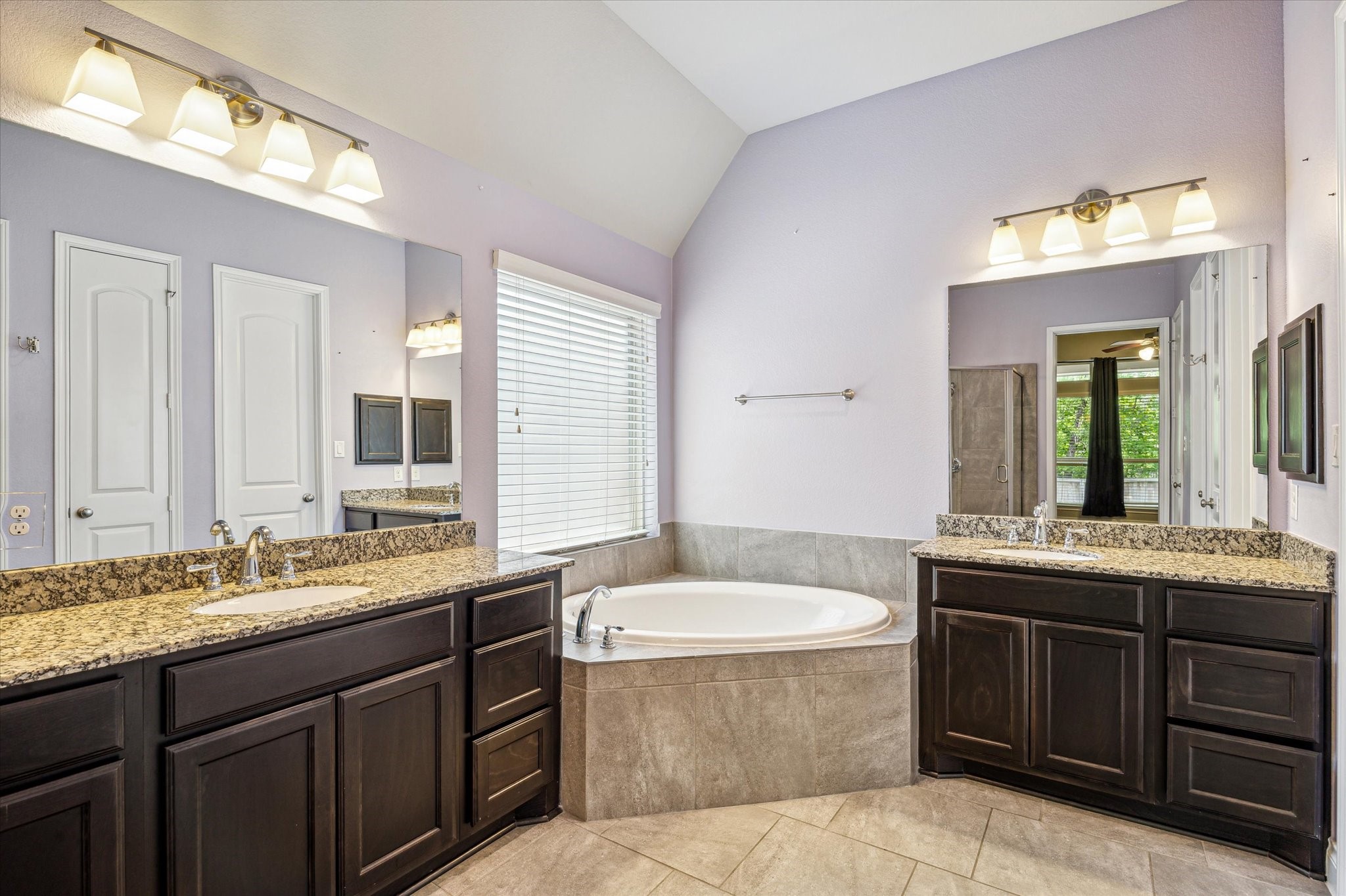 253 Trillium Park Loop Conroe, TX 77304 - Photo 22 of 37 a bathroom with a granite countertop bathtub sink and mirror