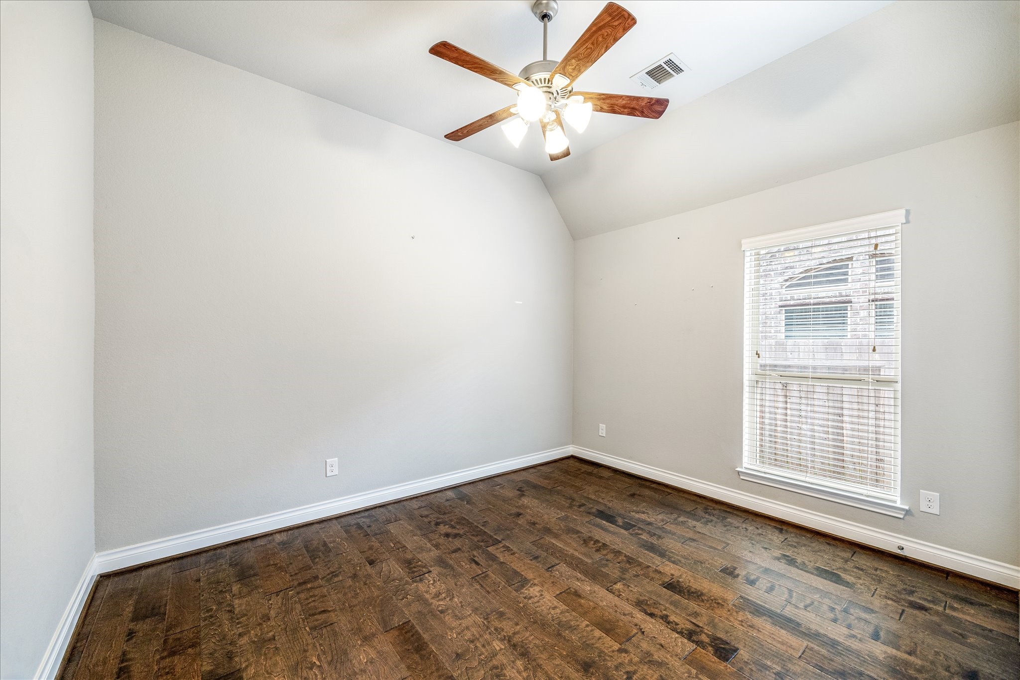 253 Trillium Park Loop Conroe, TX 77304 - Photo 25 of 37 an empty room with wooden floor and ceiling fan