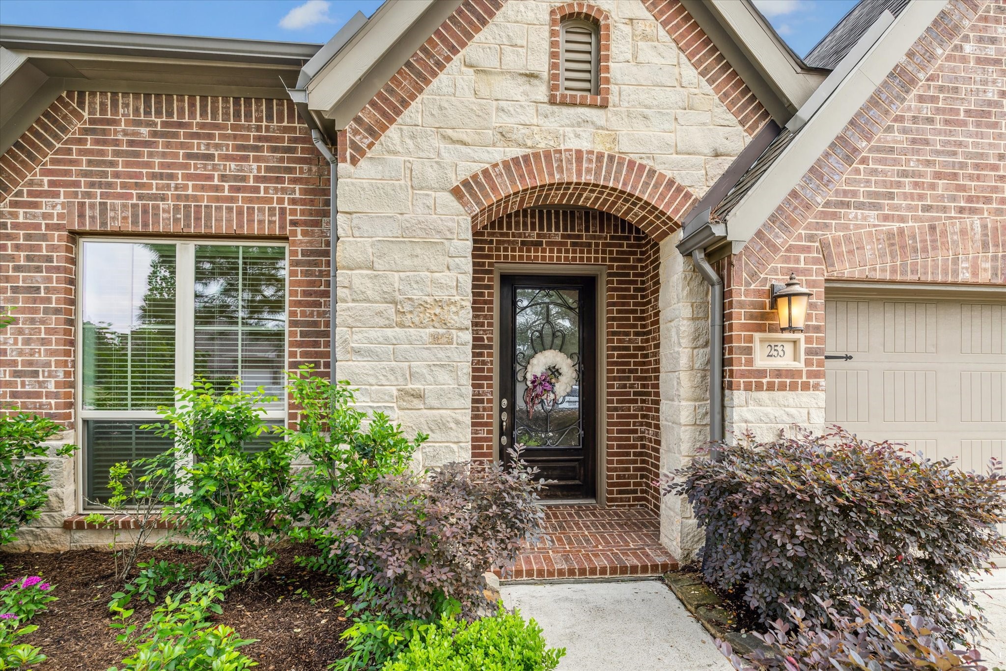 253 Trillium Park Loop Conroe, TX 77304 - Photo 3 of 37 a front view of a house with garden