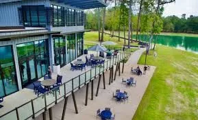 a view of two chairs and table in patio with swimming pool