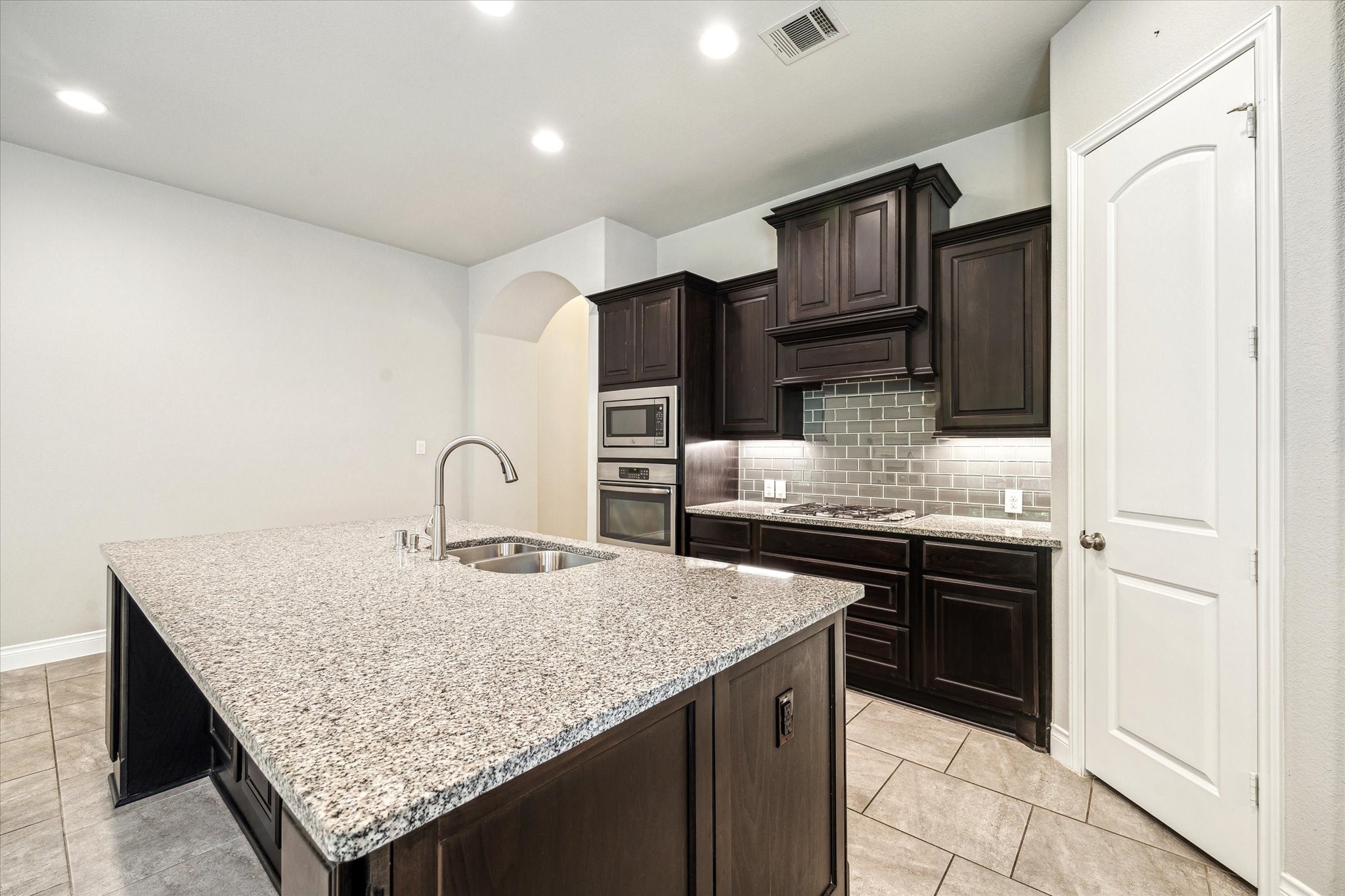 253 Trillium Park Loop Conroe, TX 77304 - Photo 9 of 37 a kitchen with stainless steel appliances granite countertop a sink refrigerator and cabinets
