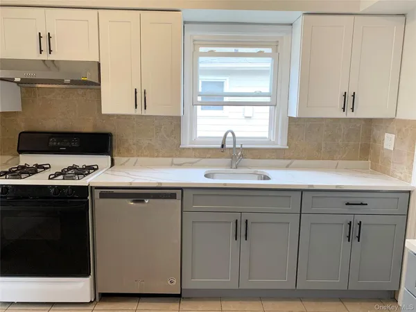 a kitchen with cabinets appliances and a sink