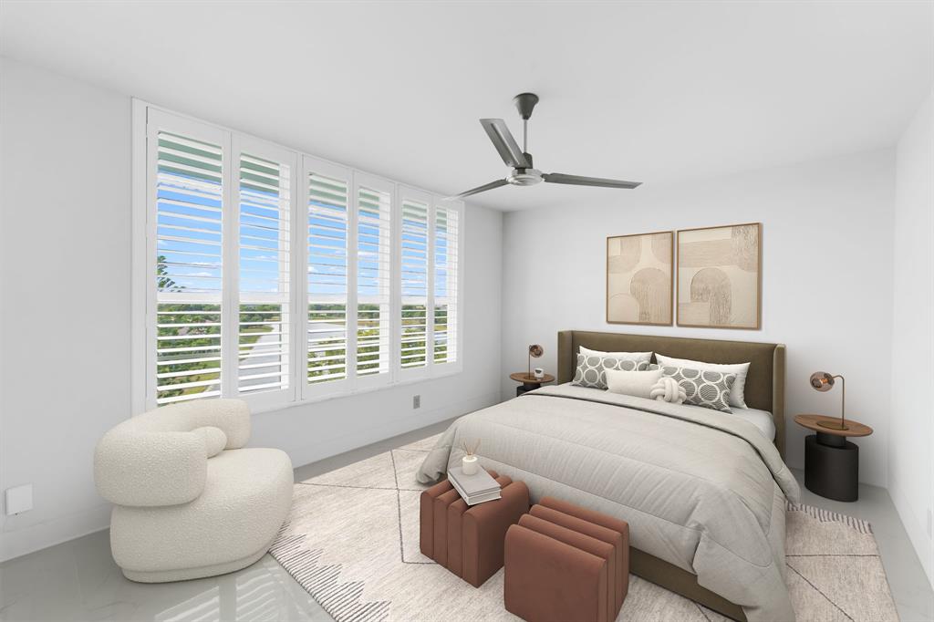 3010 North Course Drive, Unit 911 Pompano Beach, FL 33069 - Photo 12 of 13 a bedroom with a bed and a large window