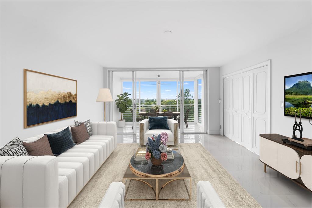 3010 North Course Drive, Unit 911 Pompano Beach, FL 33069 - Photo 2 of 13 a living room with furniture large window and flat screen tv