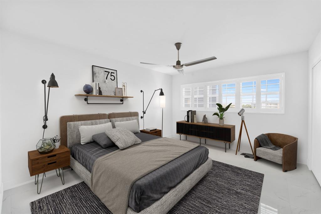 3010 North Course Drive, Unit 911 Pompano Beach, FL 33069 - Photo 8 of 13 a bedroom with a bed and wooden floor