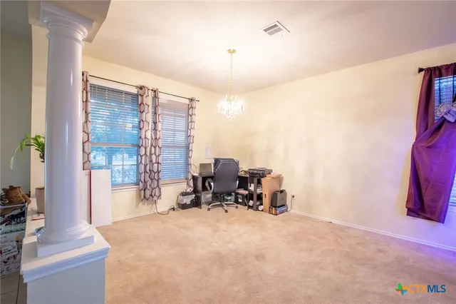 a view of living room with furniture and a floor to ceiling window