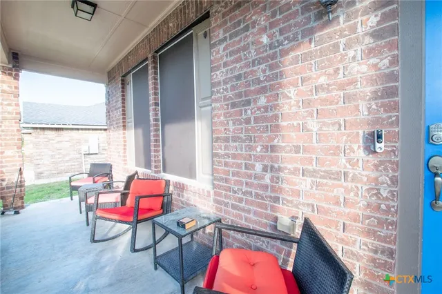 a balcony with chairs and outdoor seating