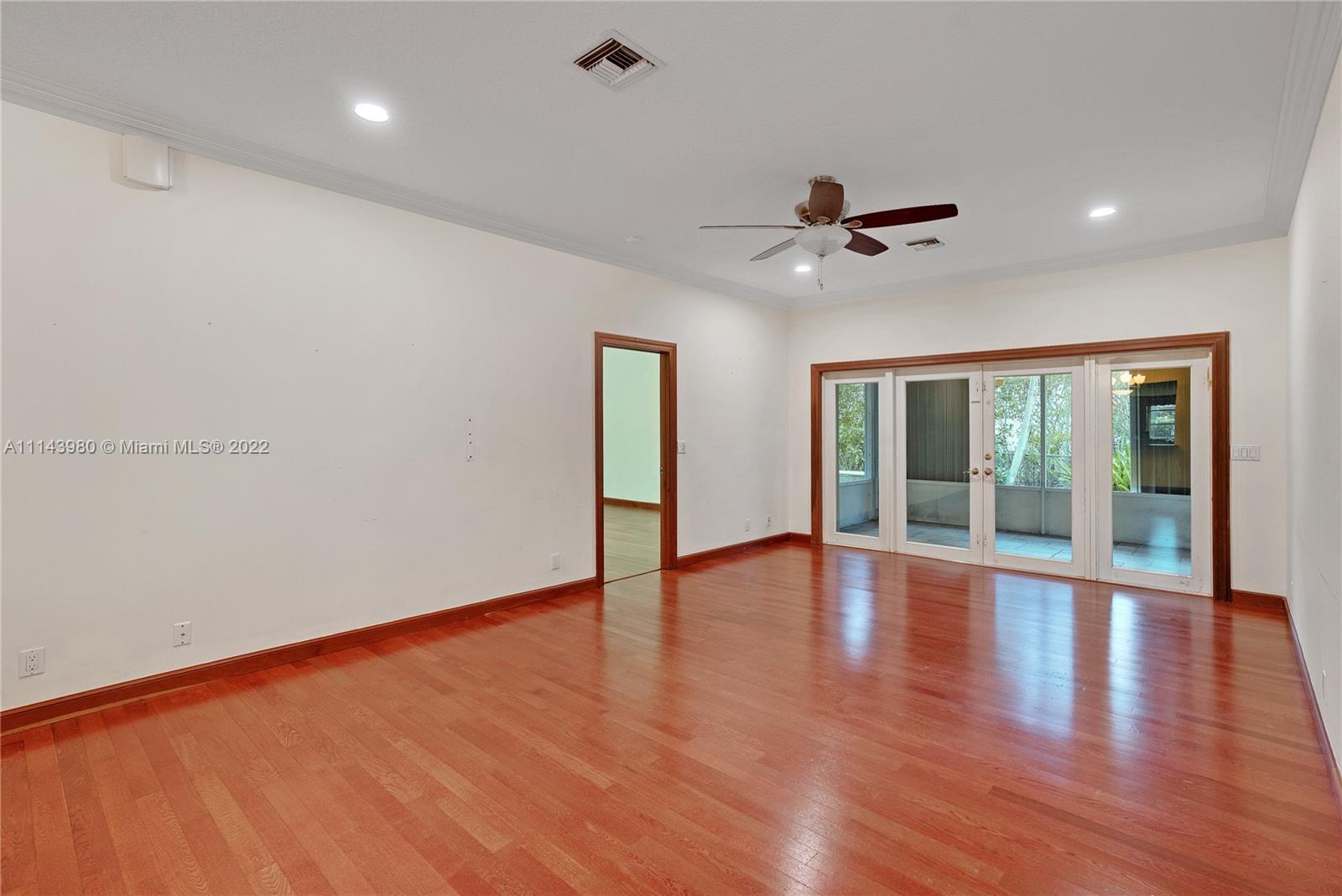 323 Cardinal Avenue Boca Raton, FL 33486 - Photo 16 of 56 a view of an empty room with wooden floor and a window