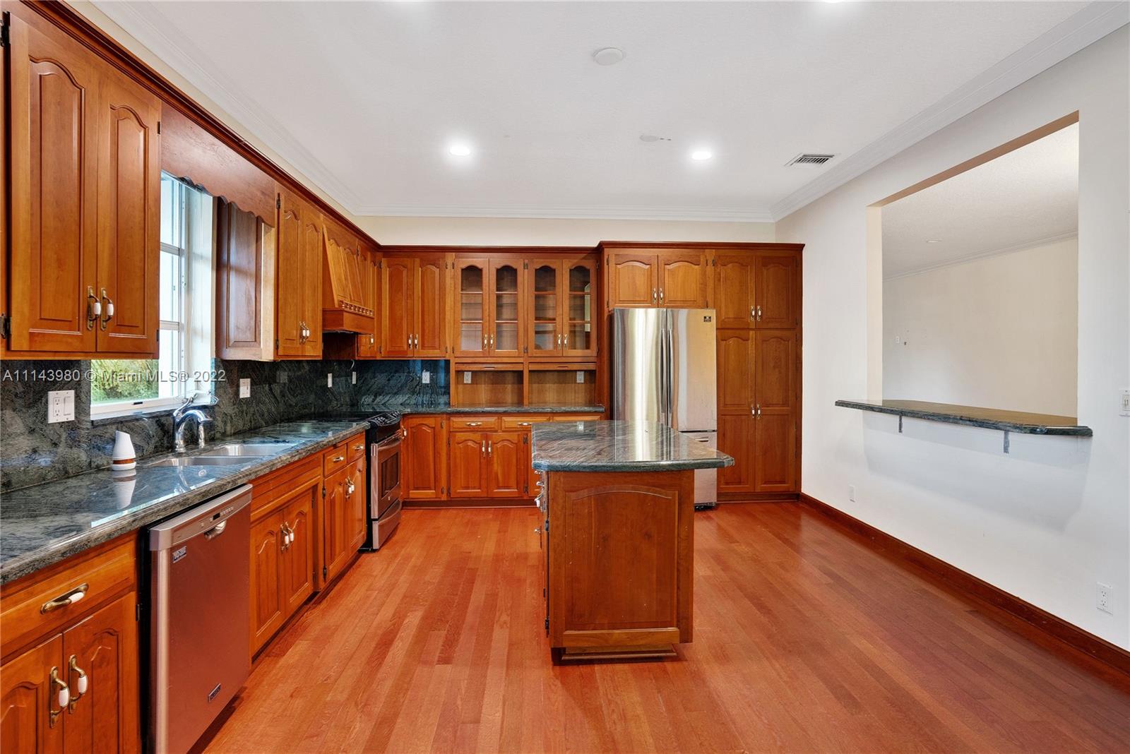 323 Cardinal Avenue Boca Raton, FL 33486 - Photo 23 of 56 a large kitchen with wooden floors and stainless steel appliances